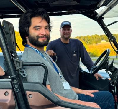 Justin Serna in a vehicle with another person behind him