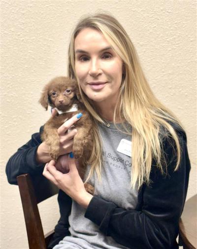 Amy Dixon holding a small puppy