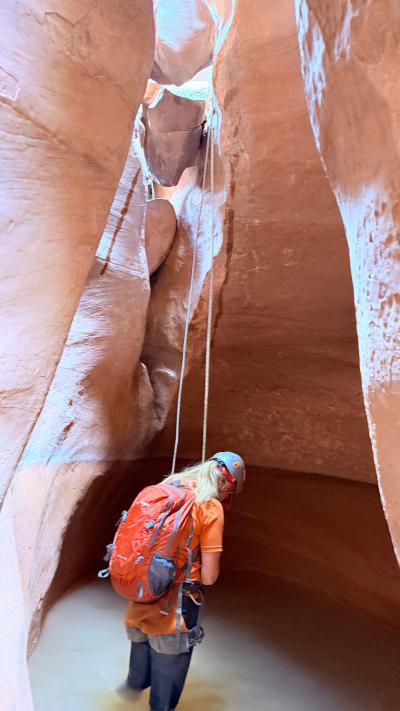 Julie Castle doing a short rapel in a slot canyon