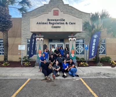 Group of people standing in front of the Brownsville Animal Regulation and Care Center building
