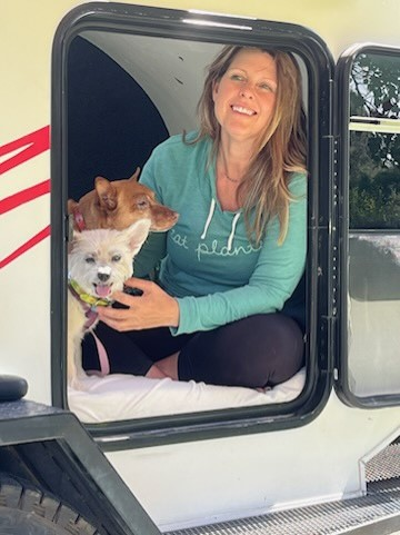 Victoria Johnson, with Angel and Bodhi the dogs, together in a small compartment