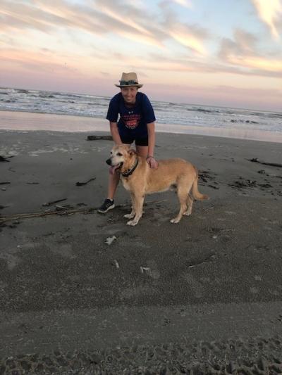 Nikki Grafnetterova with Baloo the dog on a beach