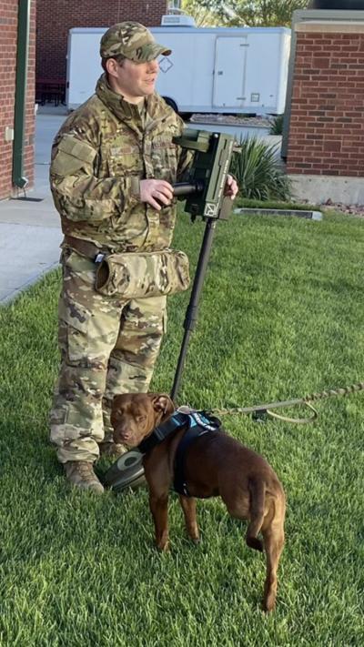 Zap the dog with his adopter, who is wearing military attire