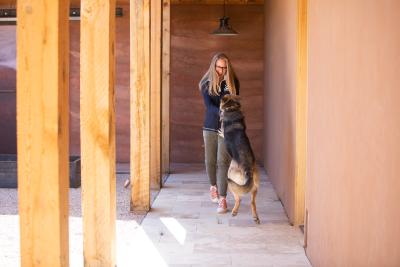 Julie Castle with her dog Sunny, who is jumping up on her