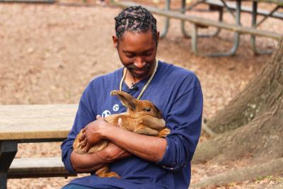 Cory Coleman cradling his rabbit Goldie in his arms