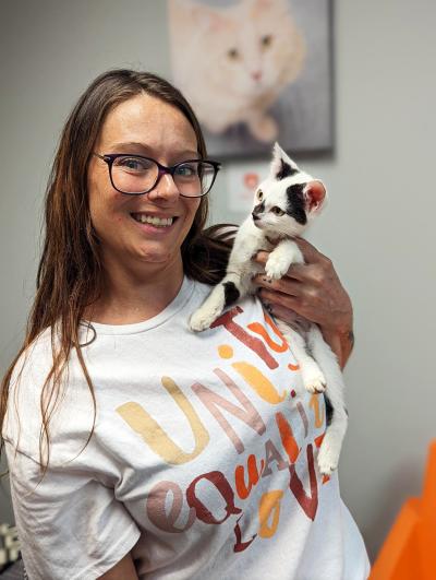 Smiling person holding Valentina the kitten