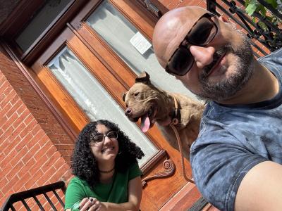 Macchiato the dog with his foster family on the stoop of their house