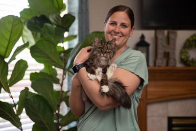 Smiling person holding a cat