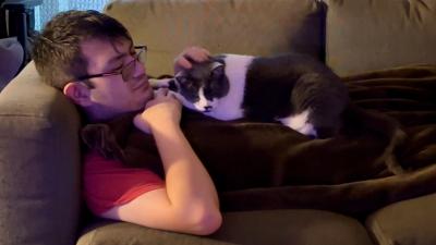 Misty the cat and David together on a couch