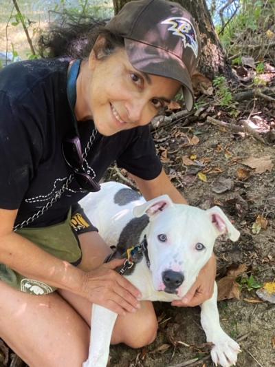 River the dog outside on a walk with his adopter