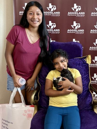 Two adopters with a kitten from Aggieland Humane Society