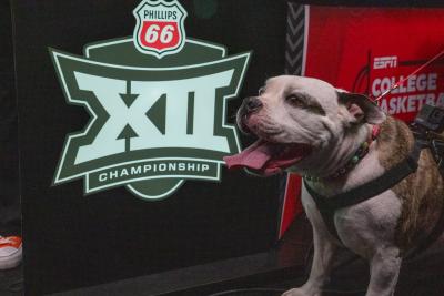 Dog in beside the Big 12 Men’s Basketball Championship logo
