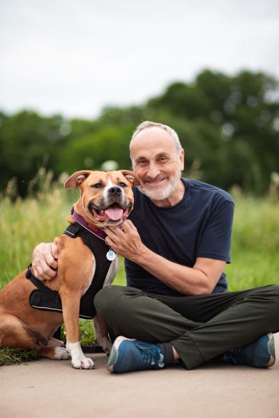 Stephen Knight outside sitting next to a dog