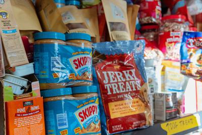 Shelf stocked full of dog treats and peanut butter