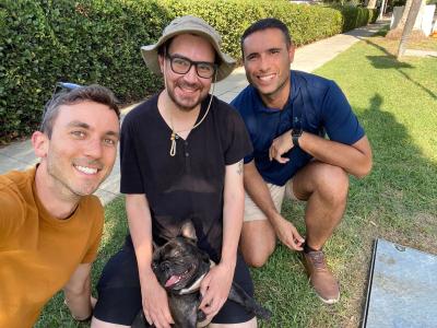 Pawrie the French bulldog with his foster dads and his new adopter