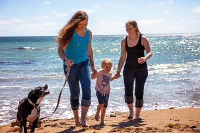 Family on a beach with a toddler and a dog