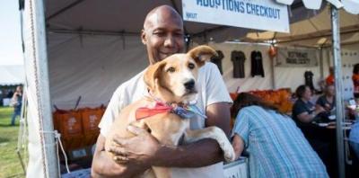 Man holding brown puppy