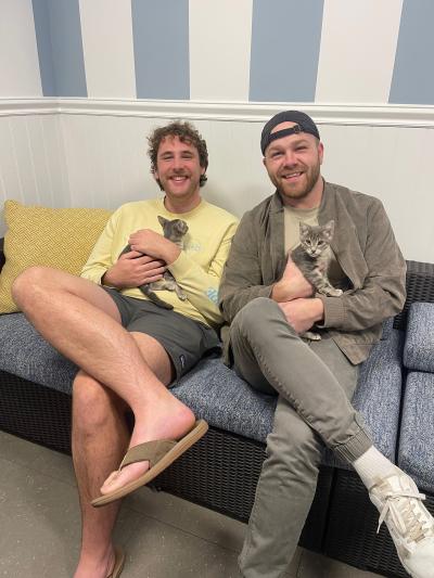 Powder and Match the kitten being held by their adopters