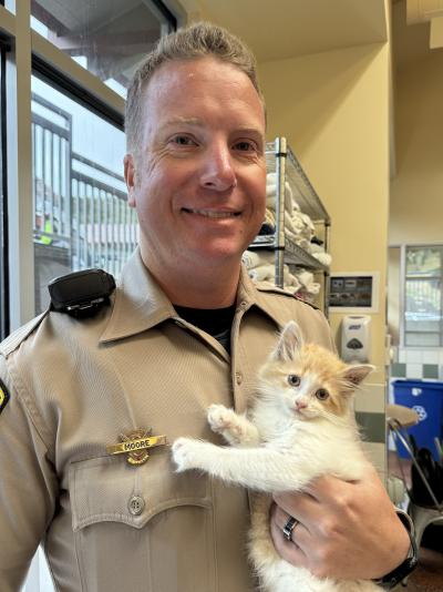 Officer Ryan Moore with Chippy the kitten