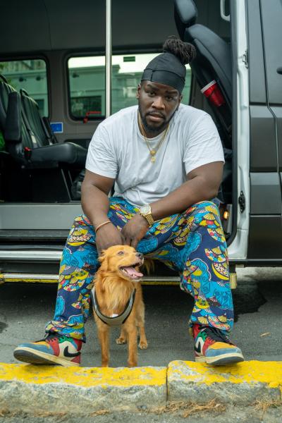Musician Kelechief with Dolph the dog