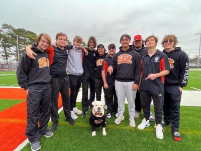 The St. Pius X High School rugby team with Buster the dog