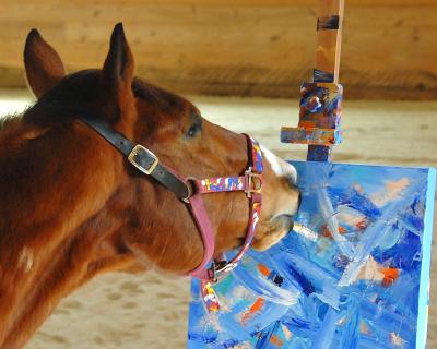 Metro the horse holding a brush in his mouth and creating a painting
