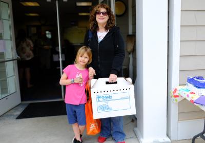 People carrying a cat carrier out of the shelter