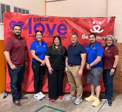 Group of people in front of a Petco Love/Best Friends backdrop