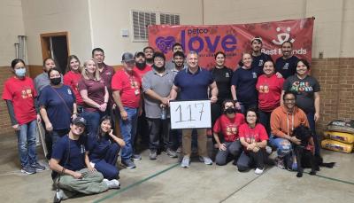 Group of people from the adoption event holding a sign with the number 117