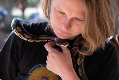 Boba the snake wrapped around Brianna's shoulders