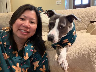 Liz Tran and Sage the dog wearing matching pajamas
