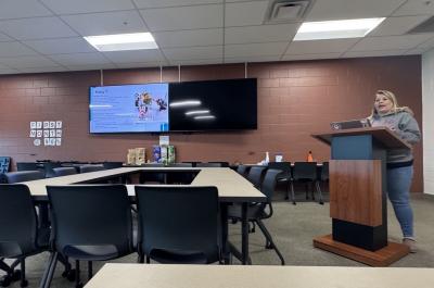 Rachel Horton giving a presentation from behind a podium