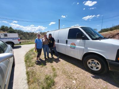 Three people beside The Pup Pickup van