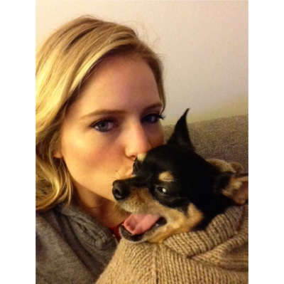Sara Haines kissing a small black and tan dog