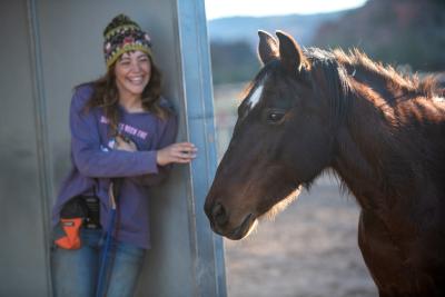 Shy DeLand playing hide-and-seek with Clint the horse