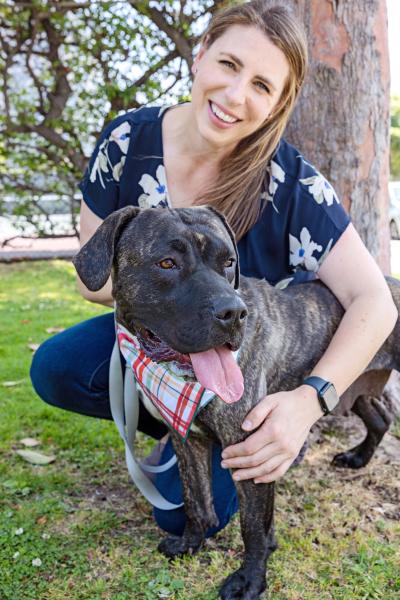 Henrietta the dog with a person whose arms are around her