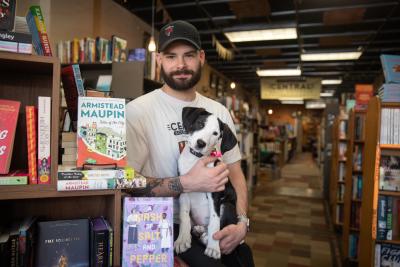 Calvin holding Sylvia the puppy in the bookstore