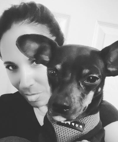 Black and white photo of Tres with a person, both with their tongues out