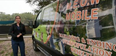 Volunteer standing next to the M.E.O.W. Mobile van
