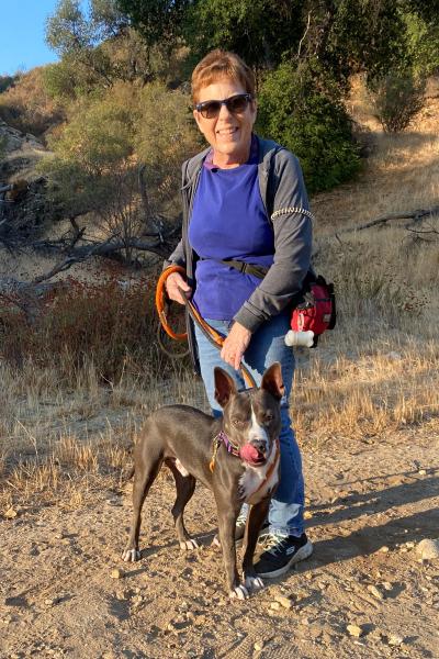 Volunteer Ginny Popovich walking a dog