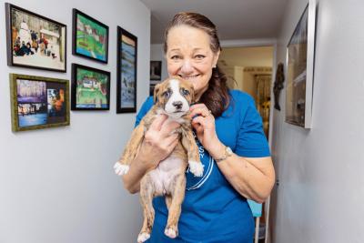 Karla holding Rosie the brindle and white puppy