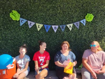 Attendees at the kitten shower, under a 'Celebrate' banner