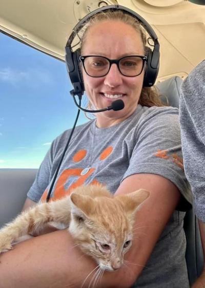 Amy Kohlbecker holding the orange kitten during the flight