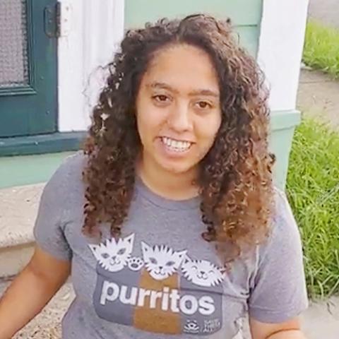 Leah smiling and wearing a purritos T-shirt