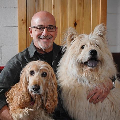 Francis Battista with two large dogs