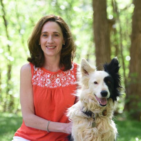 Valerie Dorian in park with black and white medium size dog