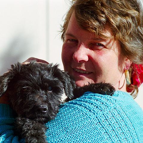 Nathania Gartman holding a small black dog