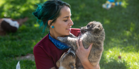 woman holding a puppy