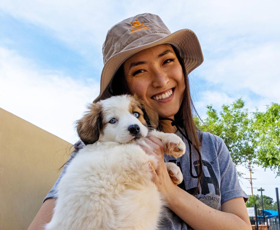 Person wearing Best Friends hat while holding pupping