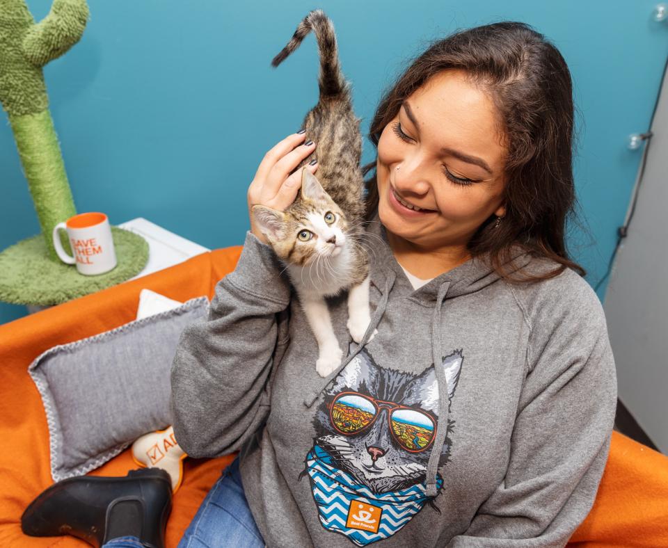 Woman with kitten sitting on shoulder